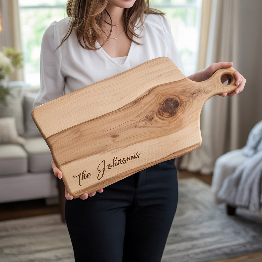 Woman holding personalized wooden cutting board engraved with the Johnsons in cozy living room