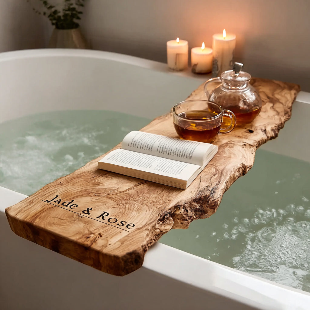 Wooden bathtub caddy with book, glass teacup, teapot, and lit candles for a relaxing spa bath